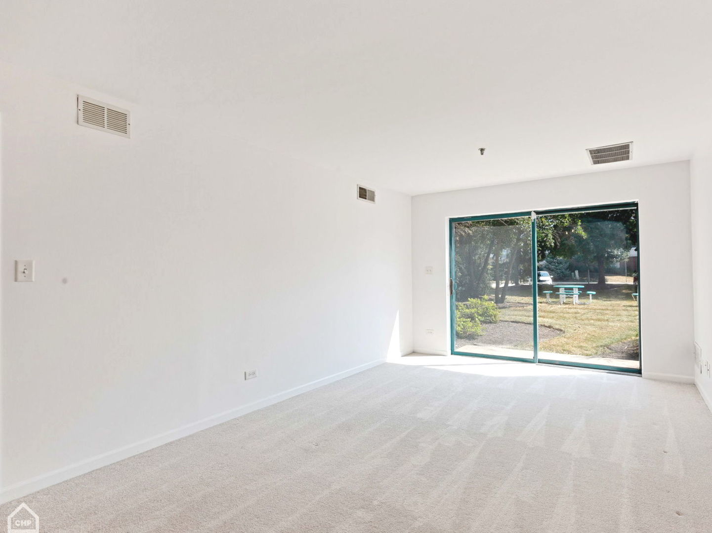 3265 Kirchoff Road, Unit 115 Rolling Meadows, IL 60008 - Photo 3 of 19 a view of an empty room with a sliding door