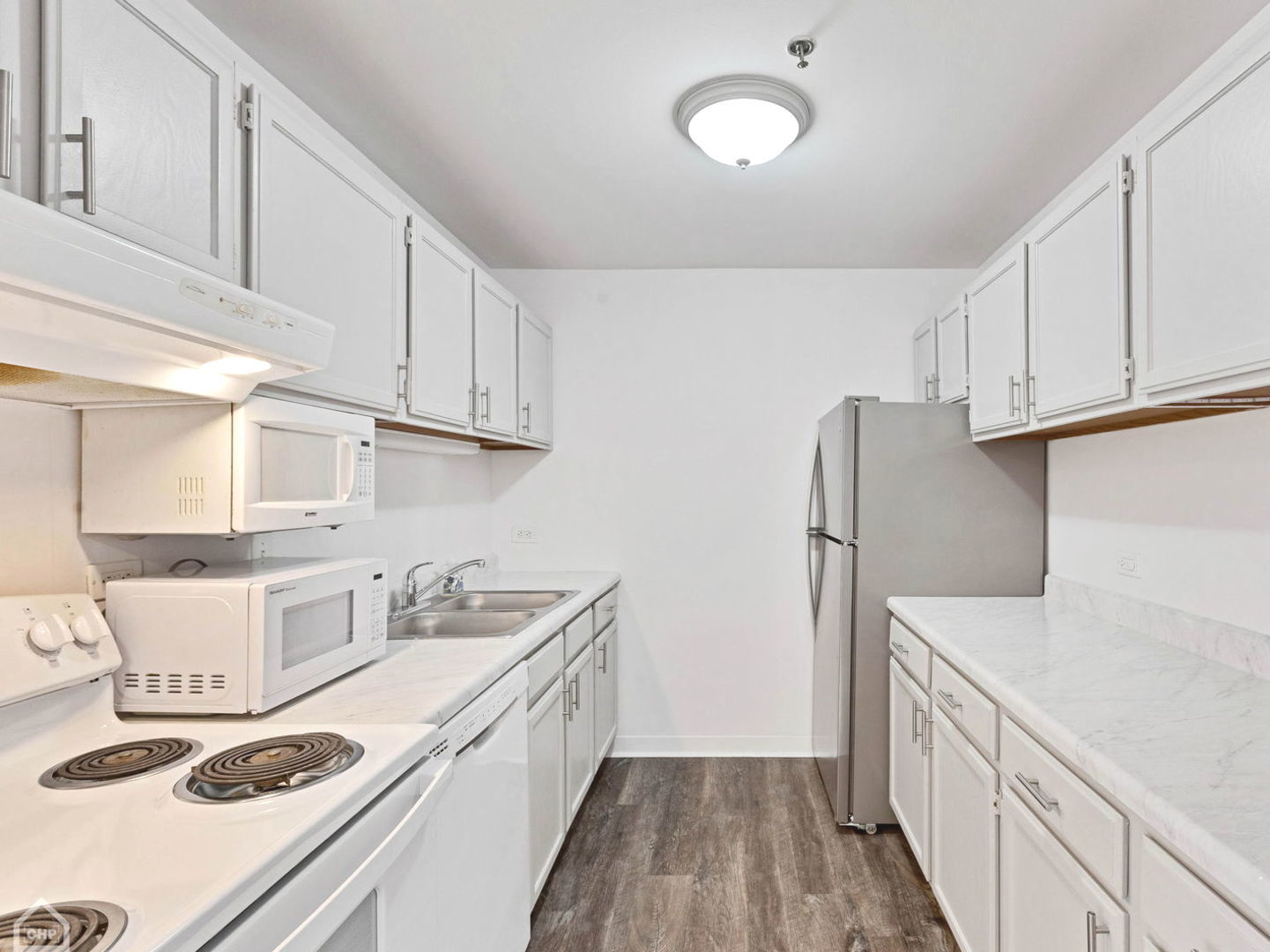 3265 Kirchoff Road, Unit 115 Rolling Meadows, IL 60008 - Photo 6 of 19 a kitchen with a sink a stove and refrigerator