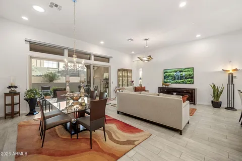 a living room with furniture a flat screen tv and a large window