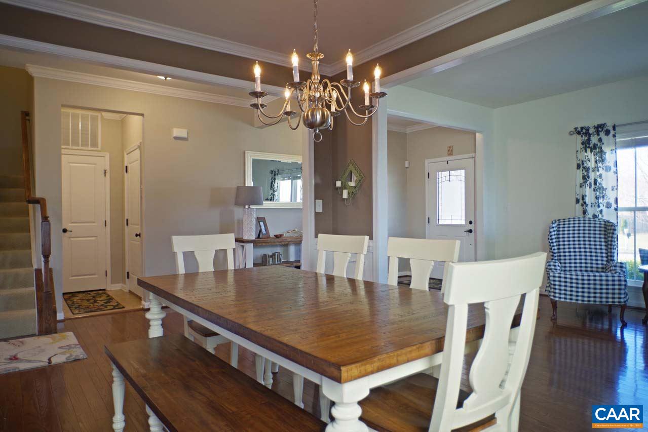 5424 Park Road Crozet, VA 22932 - Photo 11 of 50 a dining room with wooden floor a chandelier a wooden table and chairs