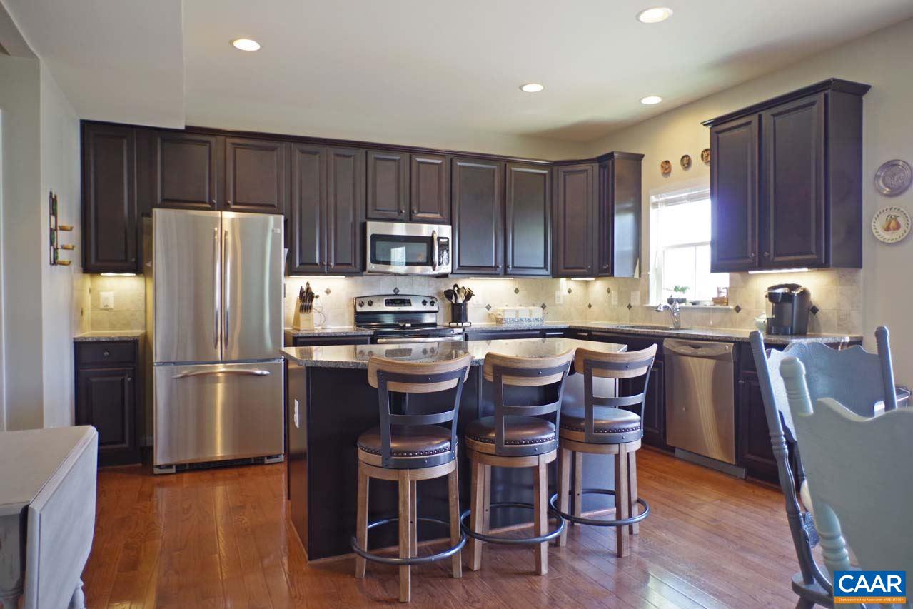 5424 Park Road Crozet, VA 22932 - Photo 13 of 50 a kitchen with kitchen island granite countertop wooden floors appliances and chairs