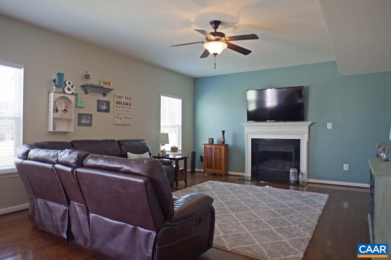 5424 Park Road Crozet, VA 22932 - Photo 18 of 50 a living room with furniture a fireplace and a flat screen tv