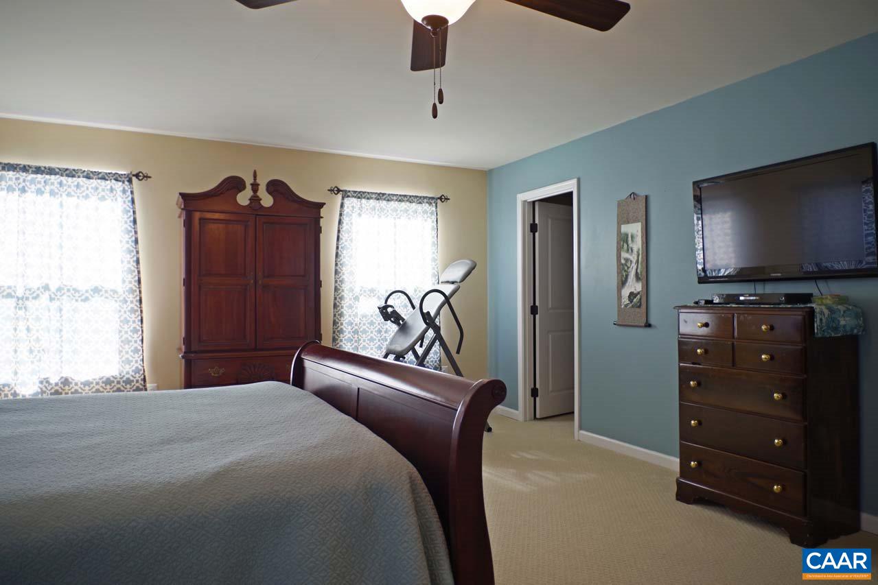 5424 Park Road Crozet, VA 22932 - Photo 26 of 50 a bedroom with a bed and a flat tv screen on dresser
