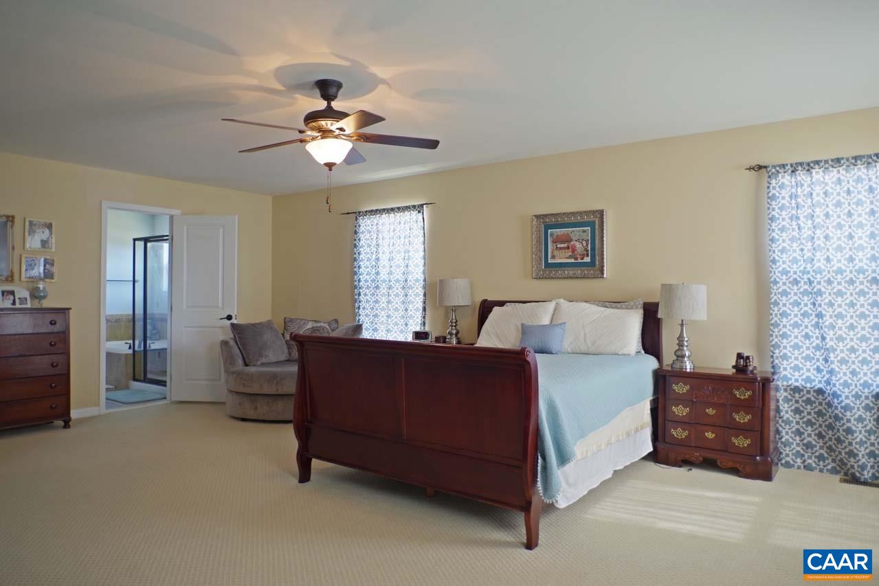 5424 Park Road Crozet, VA 22932 - Photo 27 of 50 a spacious bedroom with a bed and a chandelier