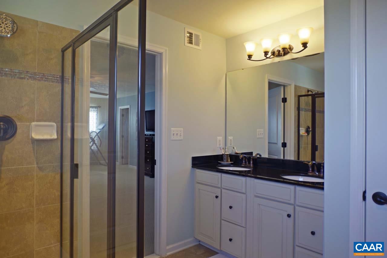 5424 Park Road Crozet, VA 22932 - Photo 28 of 50 a bathroom with a granite countertop sink and a mirror