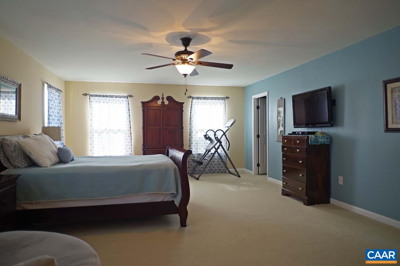 5424 Park Road Crozet, VA 22932 - Photo 31 of 50 a bedroom with a bed and a flat tv screen on the dresser
