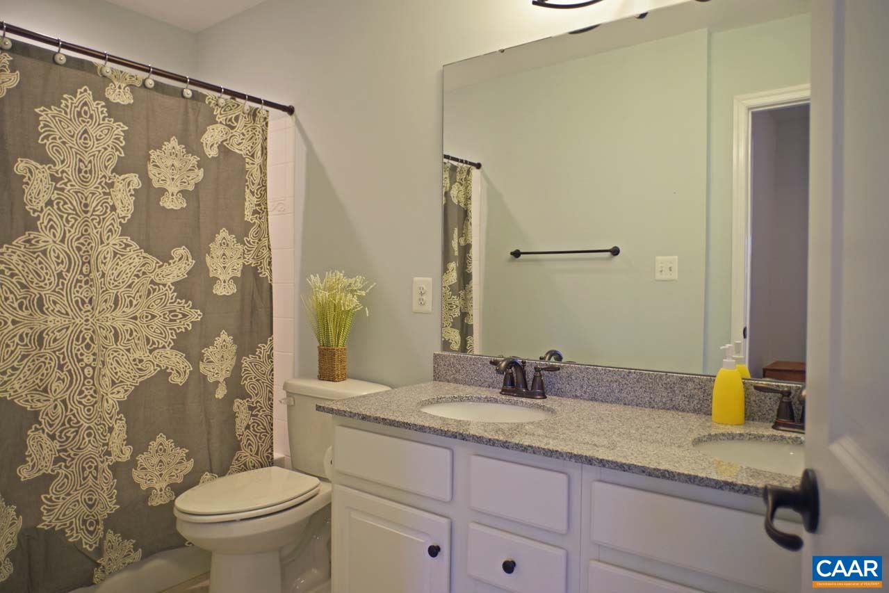 5424 Park Road Crozet, VA 22932 - Photo 36 of 50 a bathroom with a granite countertop sink a toilet and a mirror
