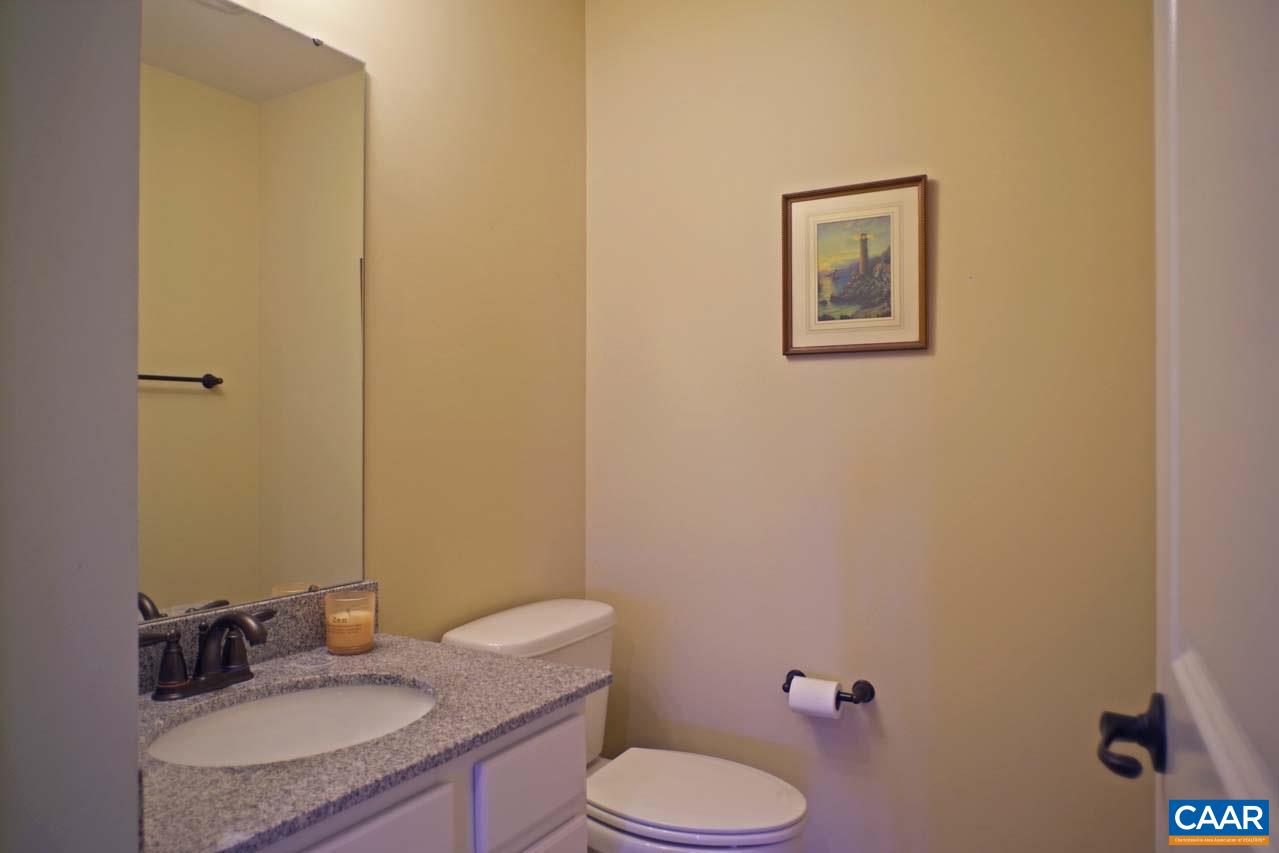 5424 Park Road Crozet, VA 22932 - Photo 42 of 50 a bathroom with a granite countertop sink mirror vanity and toilet