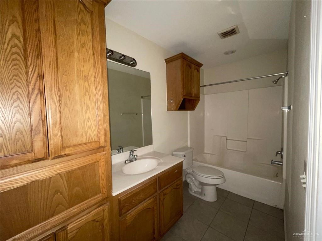 1413 Nassau Street, Unit A Edinburg, TX 78541 - Photo 6 of 9 a bathroom with a sink a toilet and shower