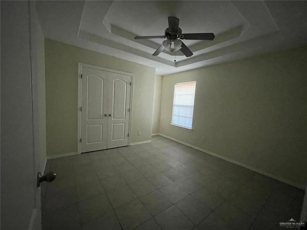 1413 Nassau Street, Unit A Edinburg, TX 78541 - Photo 8 of 9 en empty room with windows and ceiling fan