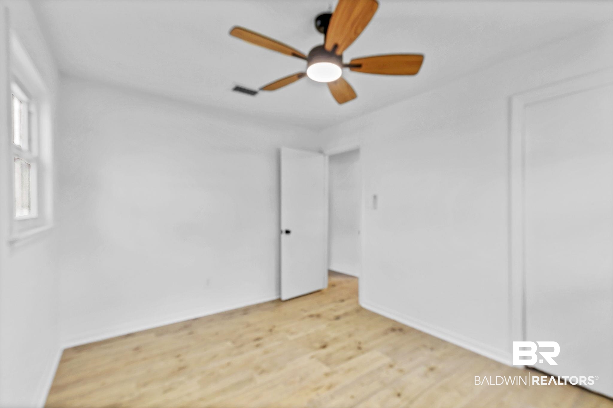 203 Anderson Road Saraland, AL 36571 - Photo 30 of 48 Unfurnished bedroom featuring light wood-style flooring, baseboards, a ceiling fan, and visible vents