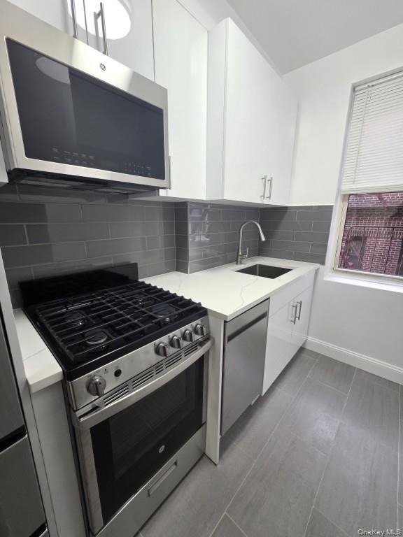 35-21 79th Street, Unit 4M Queens, NY 11372 - Photo 6 of 11 a white stove top oven sitting inside of a kitchen