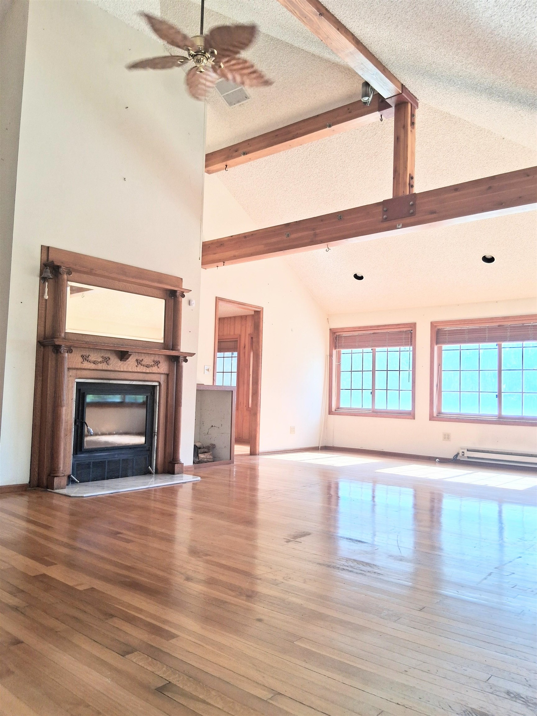 1983 River Road Fruita, CO 81521 - Photo 16 of 31 a view of empty room with wooden floor and fireplace