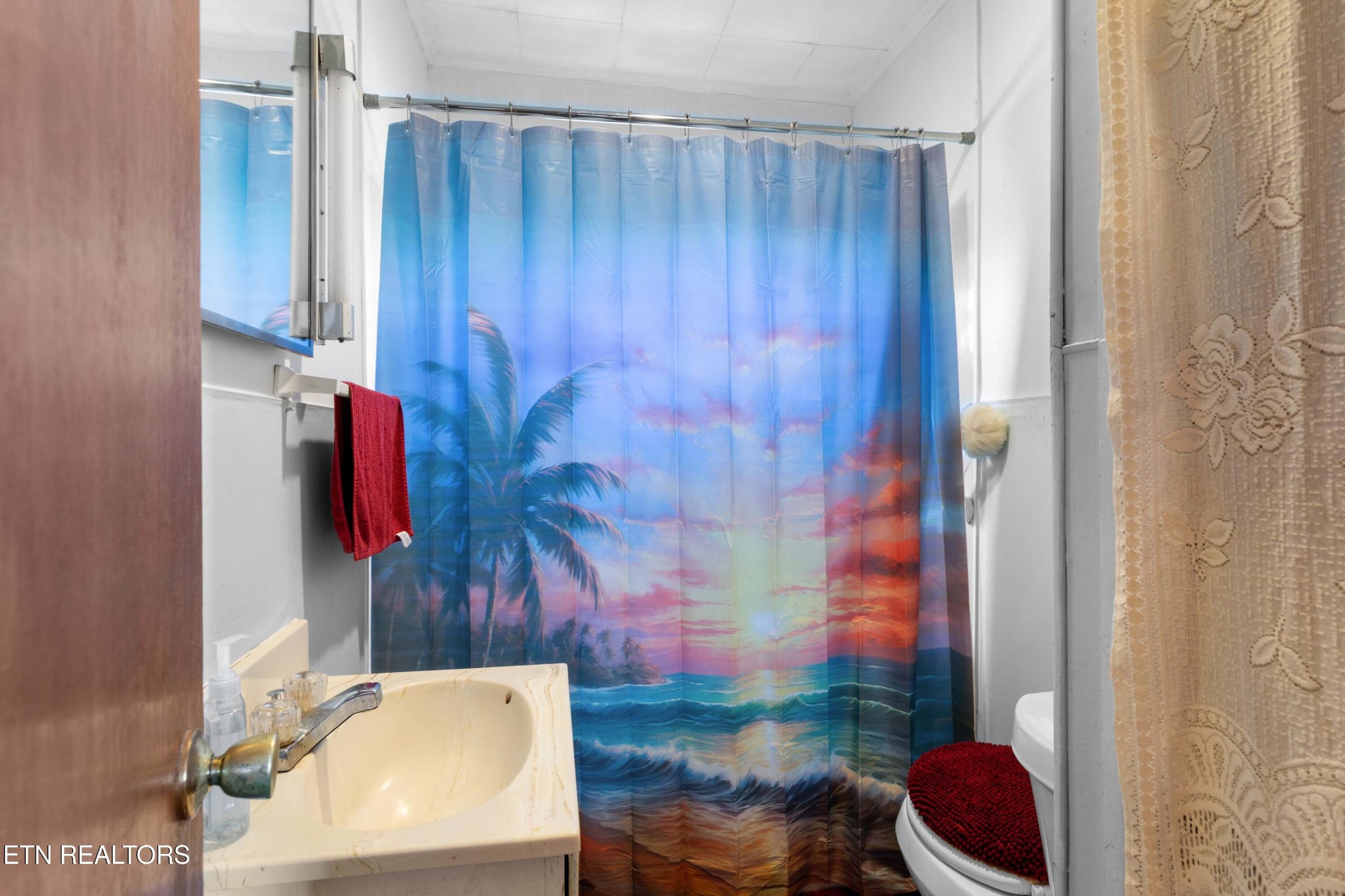 385 Hubbs Grove Road Maynardville, TN 37807 - Photo 14 of 33 a bathroom with a toilet and a shower curtain