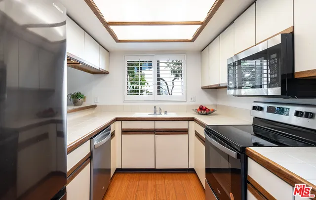 a kitchen with a sink a stove and cabinets