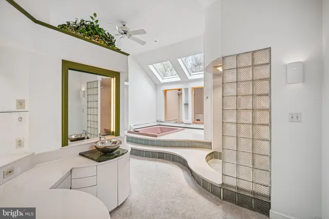 a bathroom with a tub shower and window
