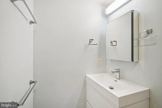 a bathroom with a sink toilet and a mirror