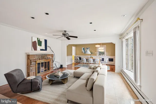 a living room with furniture fireplace and a large window