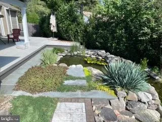 a front view of a house with a yard table and chairs