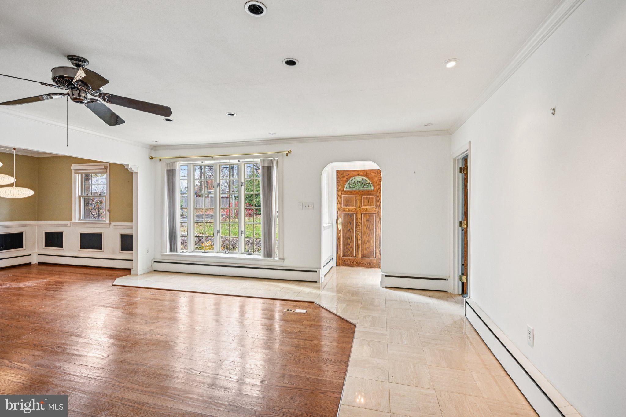 1607 Silverside Road Wilmington, DE 19810 - Photo 4 of 36 a view of an empty room with a window and wooden floor
