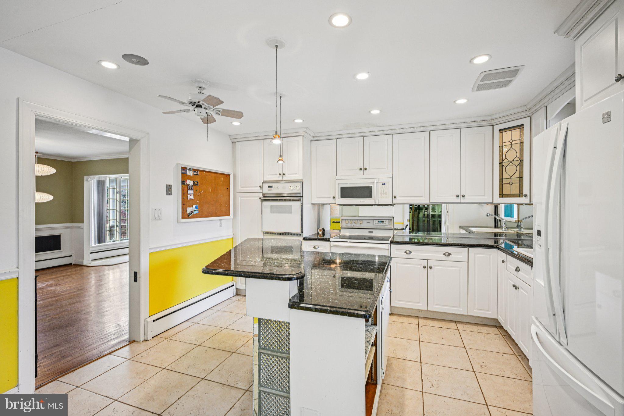 1607 Silverside Road Wilmington, DE 19810 - Photo 8 of 36 a kitchen with stainless steel appliances granite countertop a stove top oven a sink dishwasher and white cabinets with wooden floor