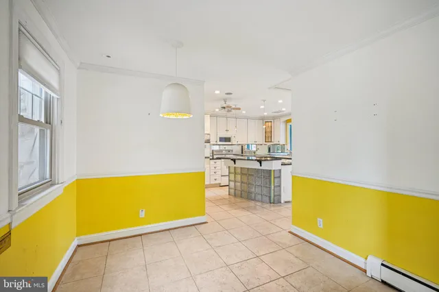a view of a kitchen with table and chairs