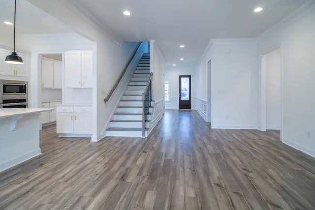 a view of a kitchen with wooden floor and electronic appliances