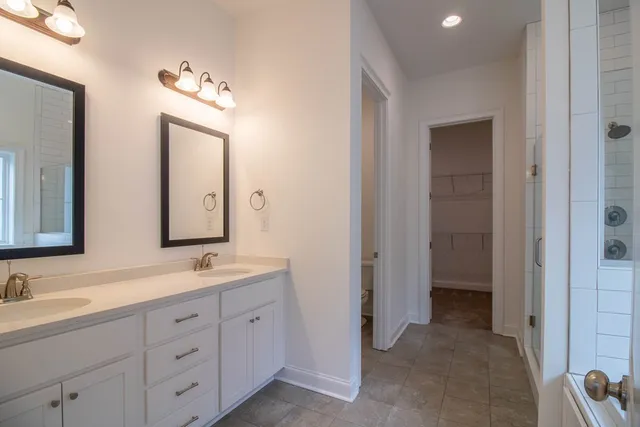 a spacious bathroom with double sink and a mirror