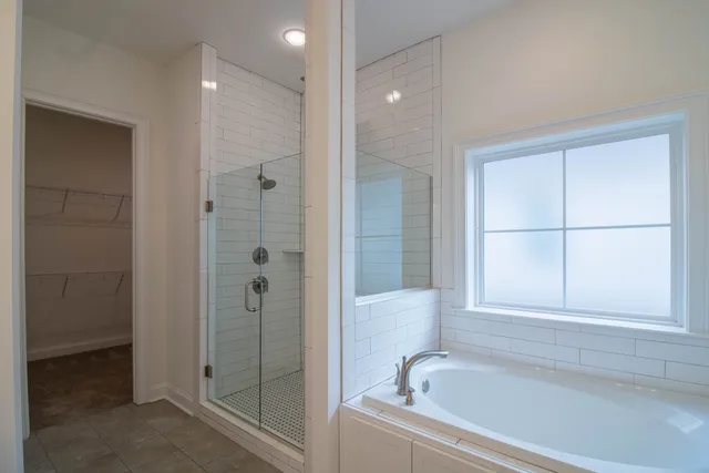 a bathroom with a bathtub and a shower