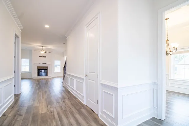 a view of a hallway with wooden floor and a fireplace