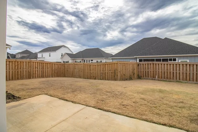 a view of an outdoor space with wooden fence