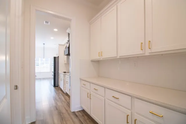 a view of a kitchen with wooden floor