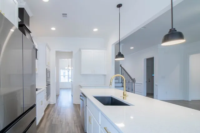 a kitchen with a sink and a refrigerator