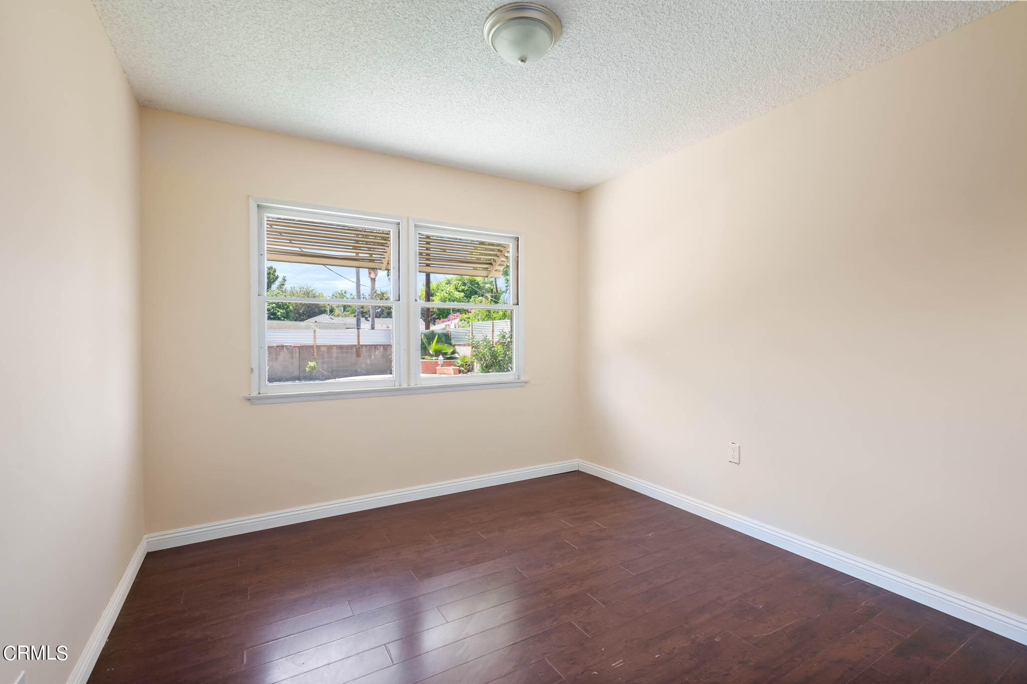 19406 Sherman Way Reseda, CA 91335 - Photo 13 of 36 an empty room with wooden floor and windows