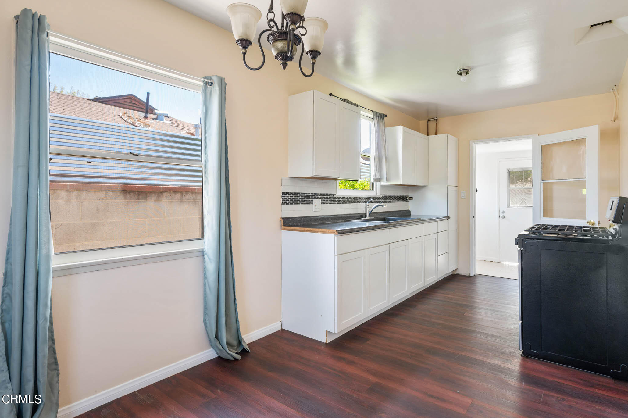 19406 Sherman Way Reseda, CA 91335 - Photo 22 of 36 a kitchen with a refrigerator cabinets and wooden floor