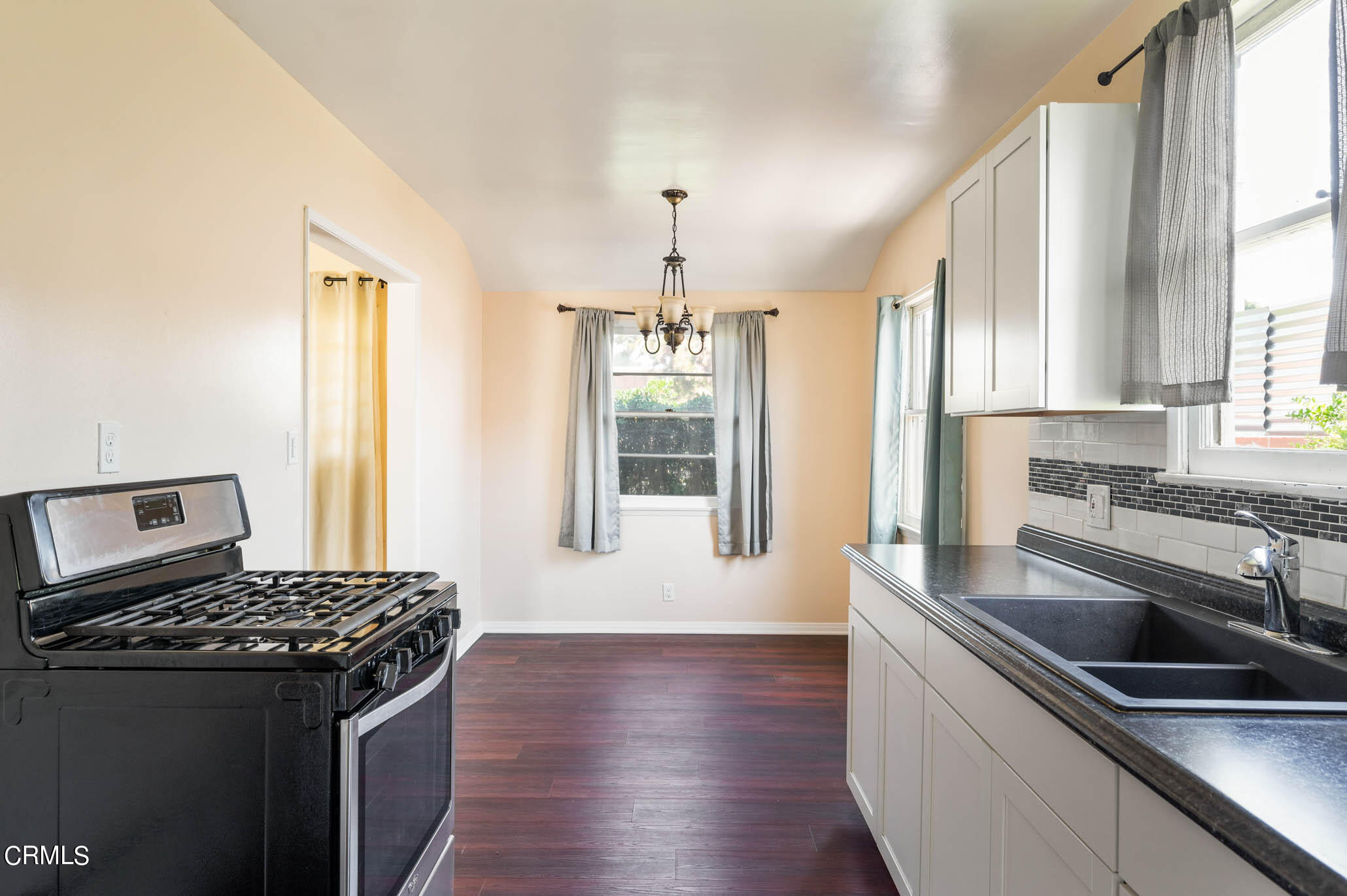 19406 Sherman Way Reseda, CA 91335 - Photo 28 of 36 a kitchen with granite countertop a stove and a sink