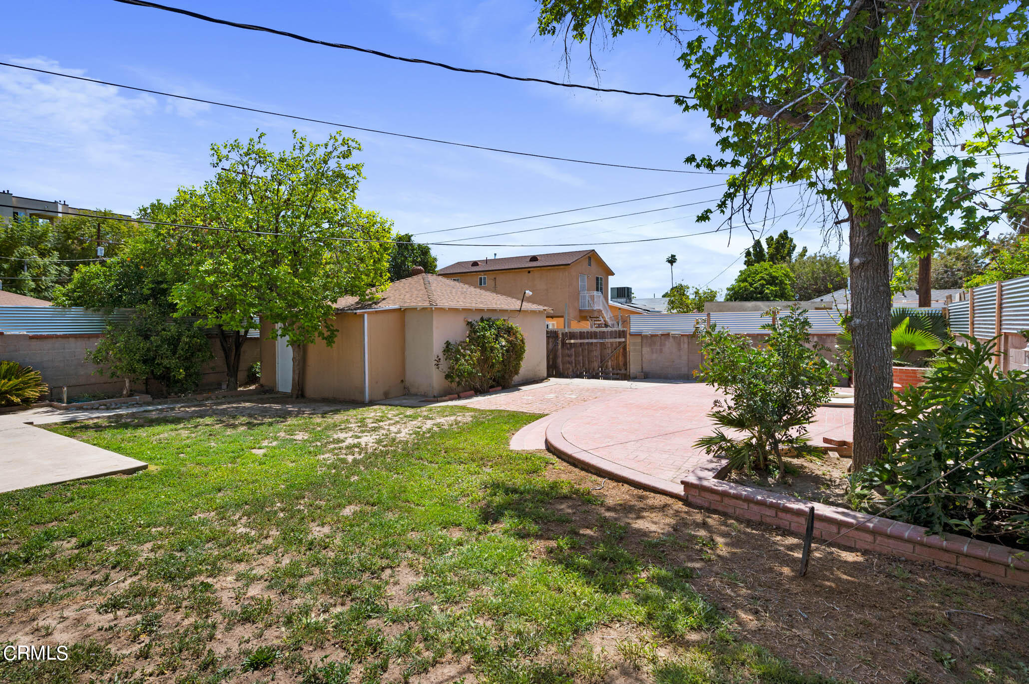 19406 Sherman Way Reseda, CA 91335 - Photo 31 of 36 a view of a backyard with potted plants and large trees