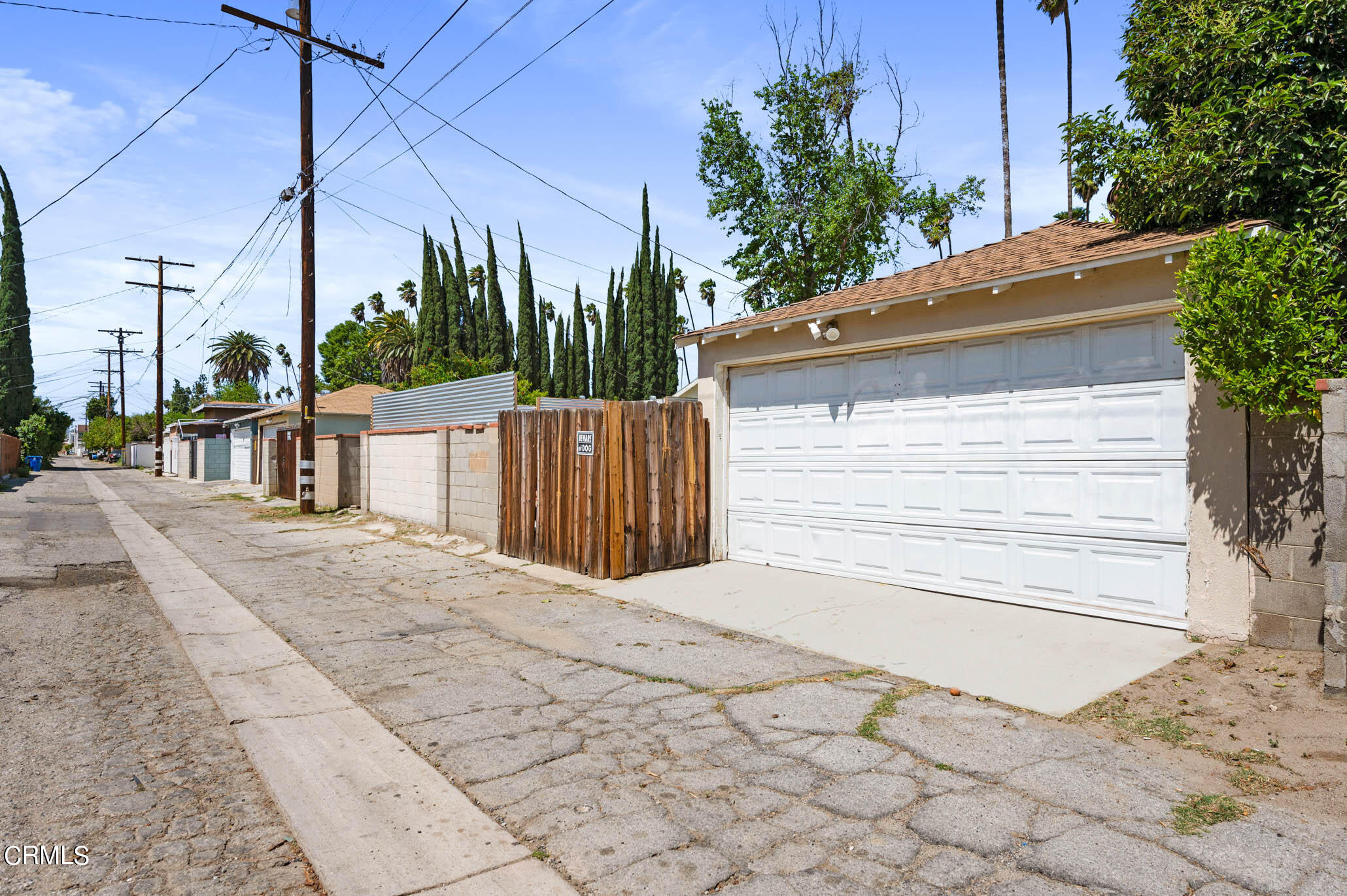 19406 Sherman Way Reseda, CA 91335 - Photo 34 of 36 a view of a white house with a small yard and plants