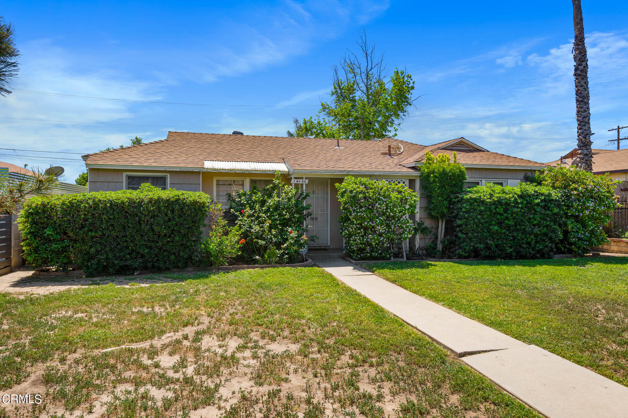 19406 Sherman Way Reseda, CA 91335 - Photo 6 of 36 a view of a garden with a building in the background