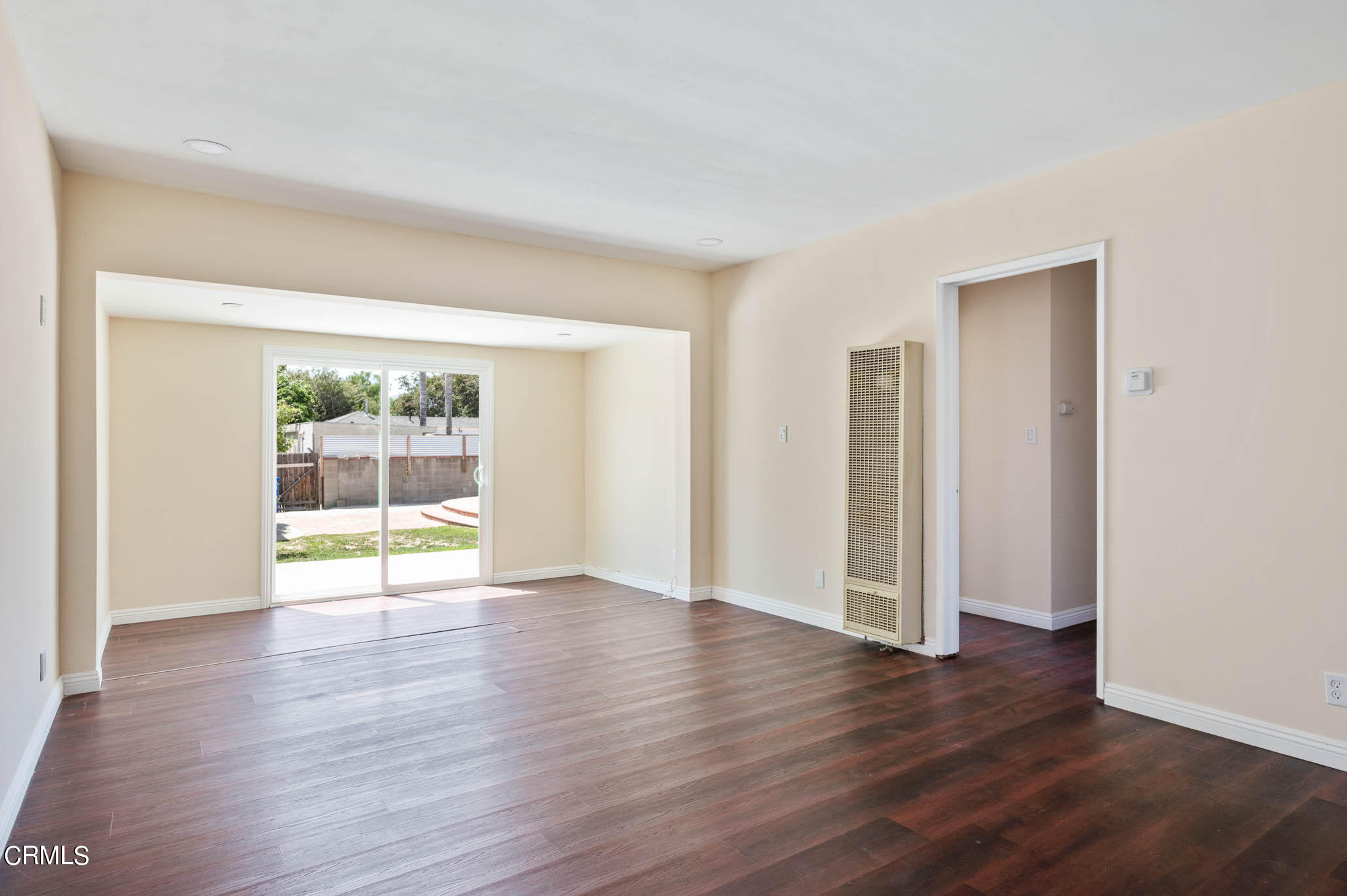 19406 Sherman Way Reseda, CA 91335 - Photo 8 of 36 an empty room with wooden floor and windows