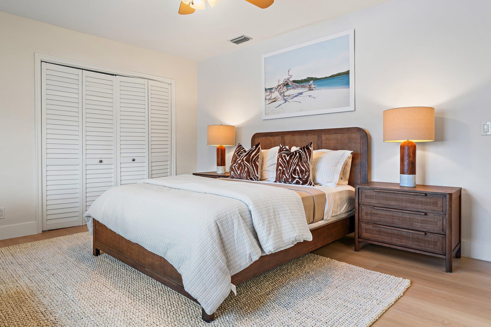 4300 Washington Road West Palm Beach, FL 33405 - Photo 16 of 27 a spacious bedroom with a bed and a lamp on table