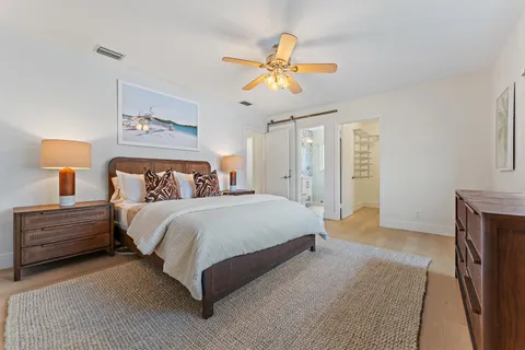 a bedroom with bed and a chandelier