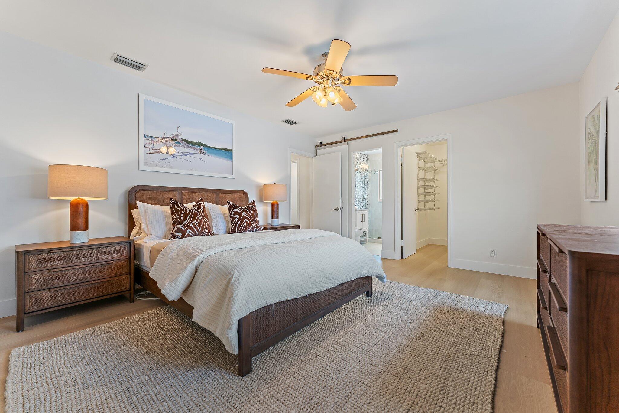 4300 Washington Road West Palm Beach, FL 33405 - Photo 17 of 27 a bedroom with a bed and a chandelier