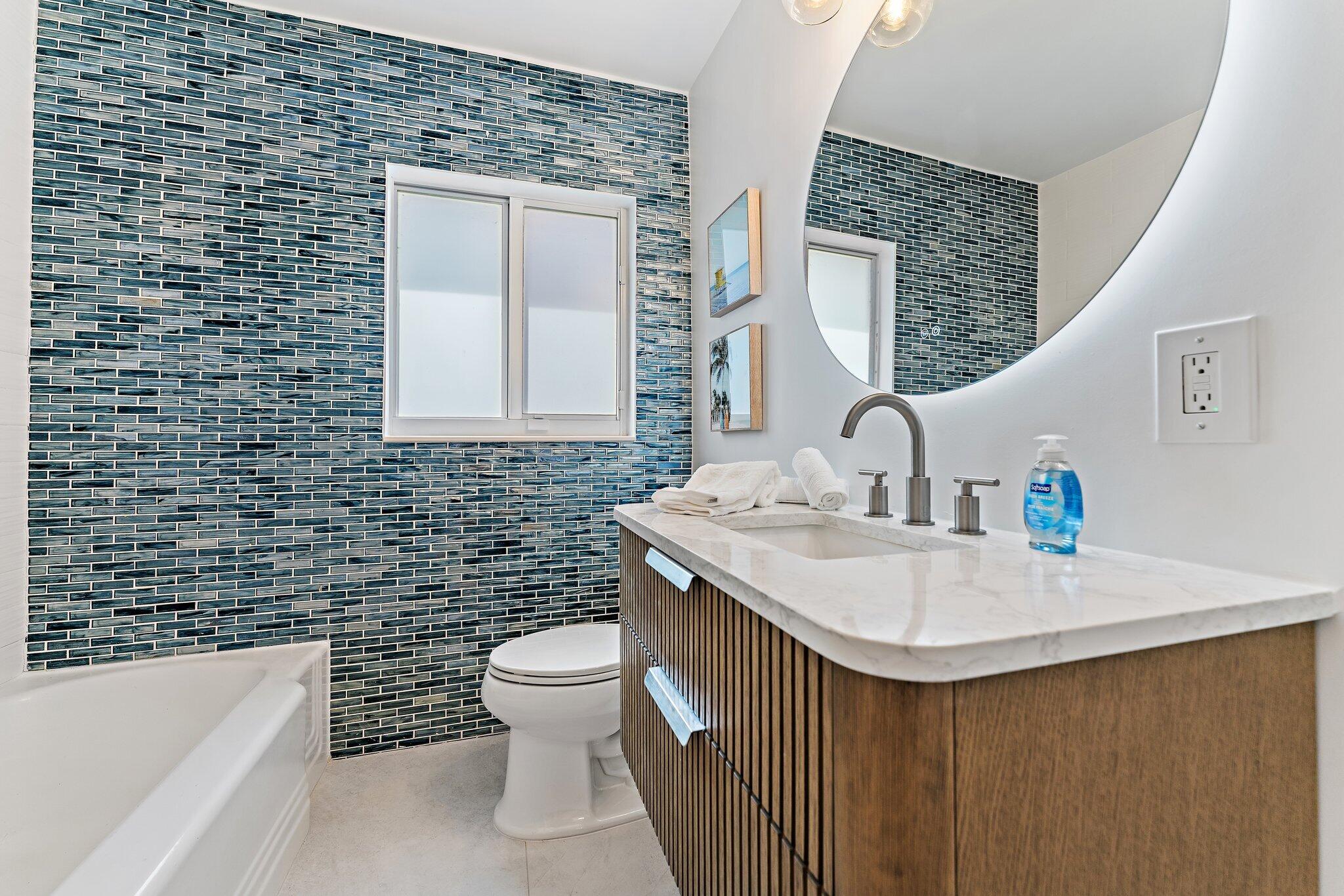4300 Washington Road West Palm Beach, FL 33405 - Photo 19 of 27 a bathroom with a sink a toilet and mirror
