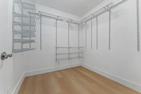 a bedroom with a bed and a mirror