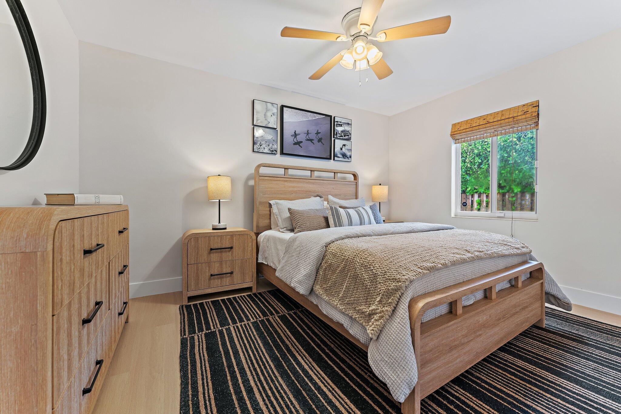 4300 Washington Road West Palm Beach, FL 33405 - Photo 27 of 27 a spacious bedroom with a bed and a chandelier