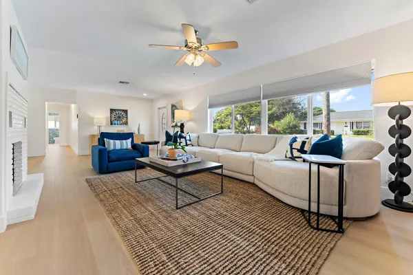 a large kitchen with stainless steel appliances kitchen island a large counter top and a view of living room