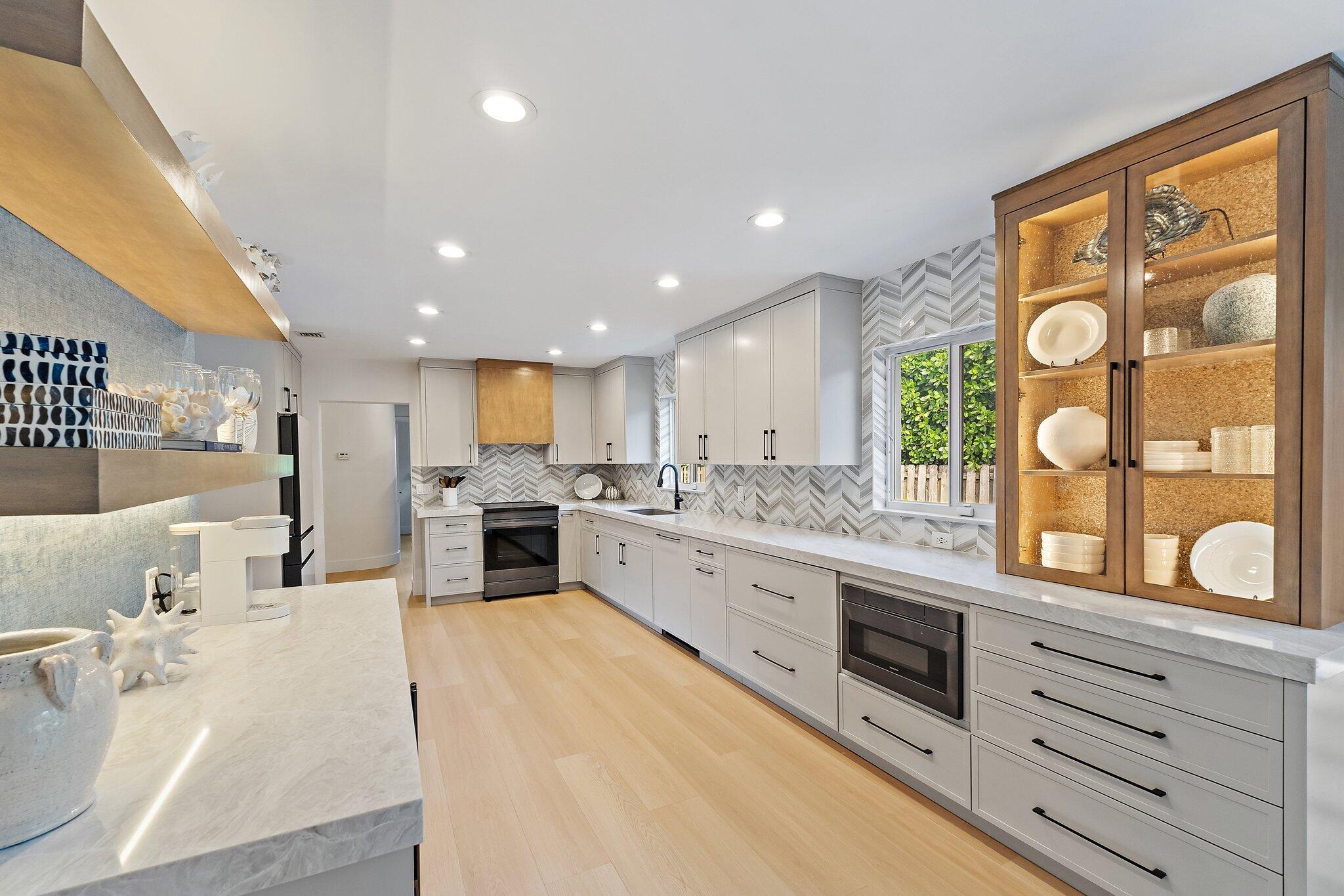 4300 Washington Road West Palm Beach, FL 33405 - Photo 8 of 27 a large white kitchen with stainless steel appliances granite countertop lots of counter top space
