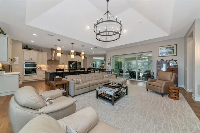 a kitchen with granite countertop a refrigerator and a stove top oven