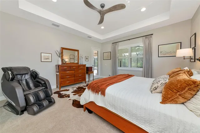 a bedroom with a bed and a lamp on dresser